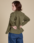 Angled back view of Denim Work Jacket in Surplus Green on Hana