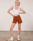 Madeline is 5’9” and wearing XXS Classic Work Shorts in Burnt Terracotta paired with Cropped Tank Top in vintage tee off-white