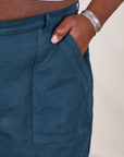 Classic Work Shorts in Lagoon front pocket close up. Elijah has their hand in the pocket.