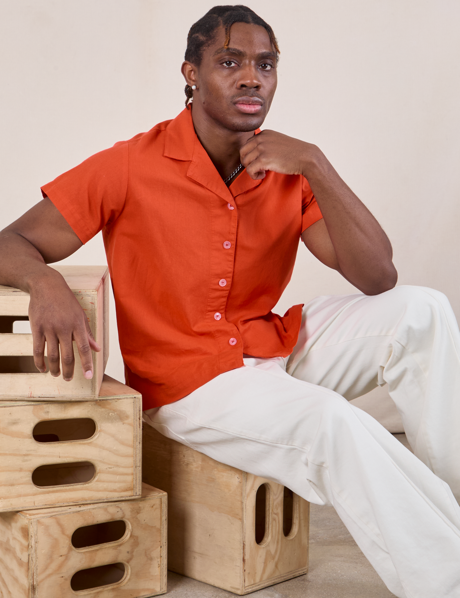 Isaac is wearing Pantry Button-Up in Chili Red and vintage tee off-white Western Pants