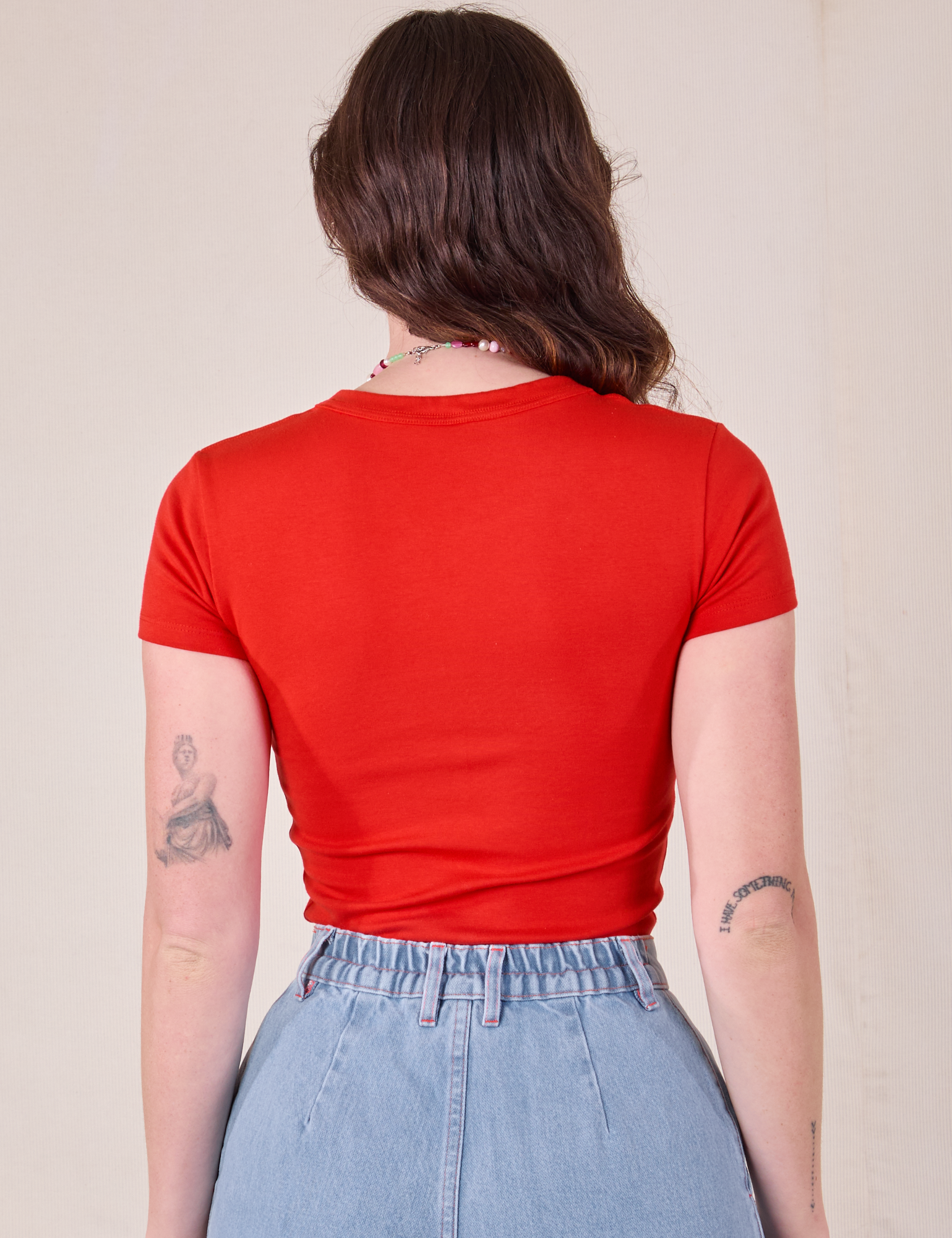 Baby Tee in Mustang Red back view on Alex