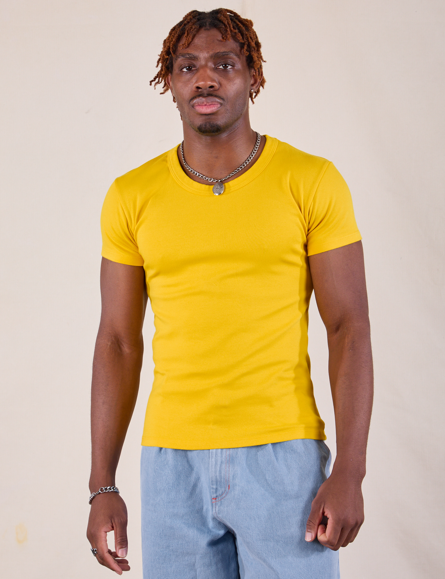 Isaac is 5'10" and wearing L Baby Tee in Golden Yellow