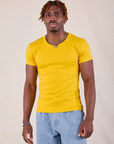 Isaac is 5'10" and wearing L Baby Tee in Golden Yellow