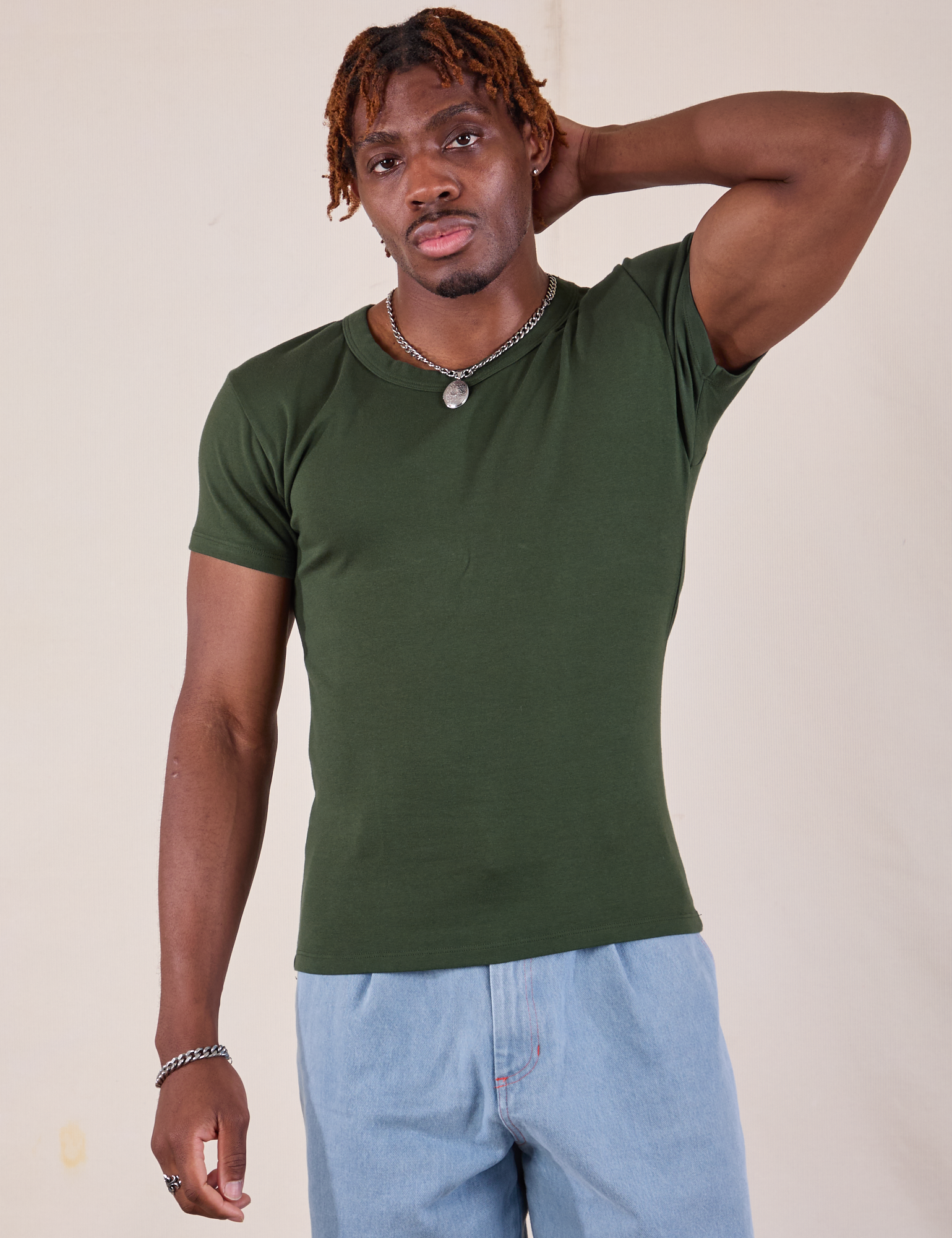 Isaac is 5'10" and wearing L Baby Tee in Swamp Green