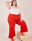 Marielena is 5'8" and wearing 2XL Bell Bottoms in Mustang Red paired with Halter Top in vintage tee off-white