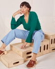 Tiara is wearing Bell Sleeve Top in Hunter Green and light wash Trouser Jeans
