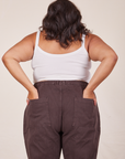 Back view of Cropped Cami in Vintage Tee Off-White and espresso brown Western Pants worn by Alicia. She has both her hands in the back pant pocket.