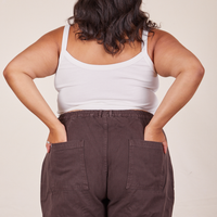 Back view of Cropped Cami in Vintage Off-White and espresso brown Western Pants worn by Alicia. She has both her hands in the back pant pocket.