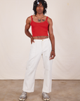 Jerrod is wearing Cropped Cami in Mustang Red and vintage off-white Western Pants