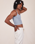Side view of Cropped Cami in Periwinkle and vintage tee off-white Western Pants worn by Jerrod