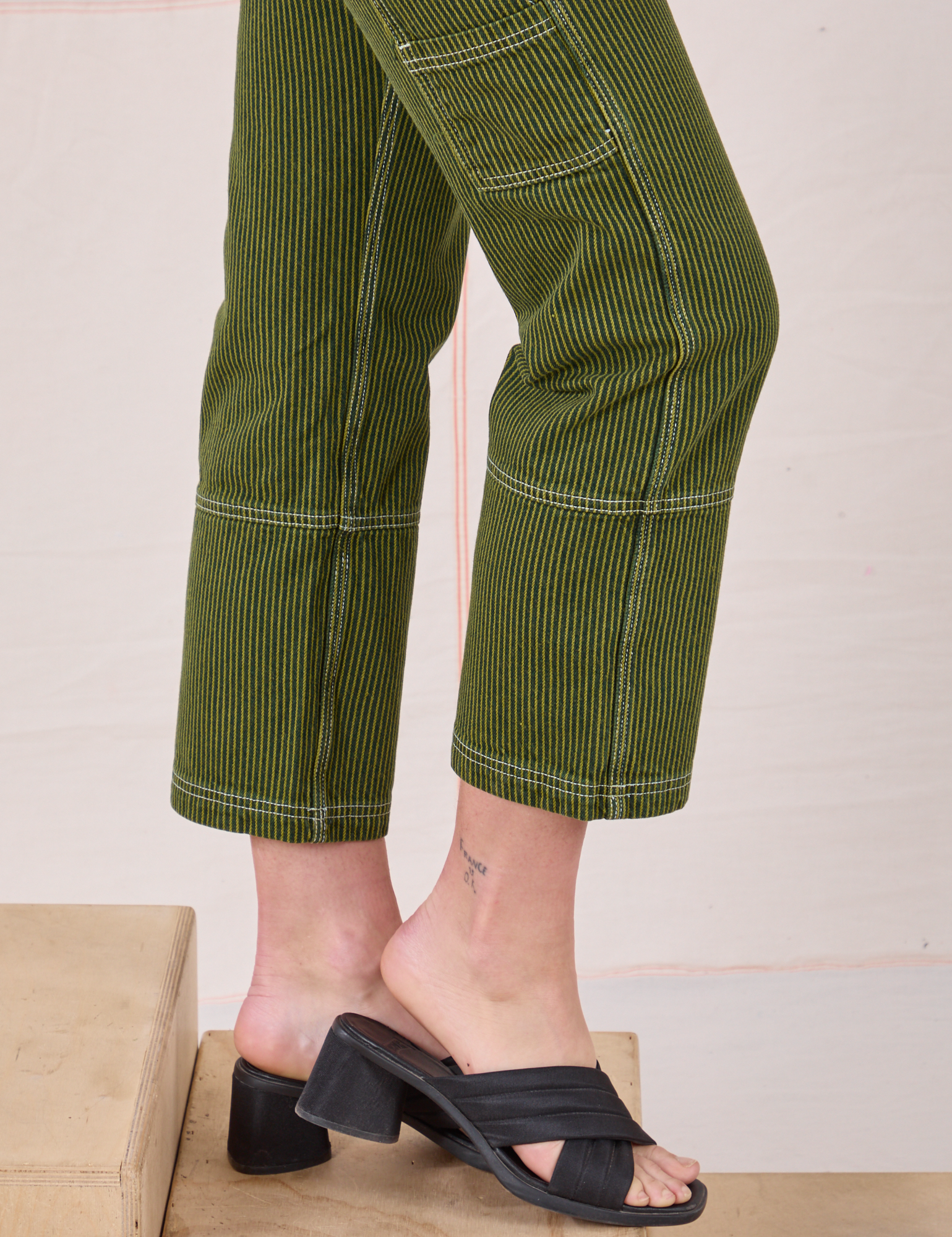 Railroad Carpenter Jeans in Summer Olive side pant leg close up on Alex
