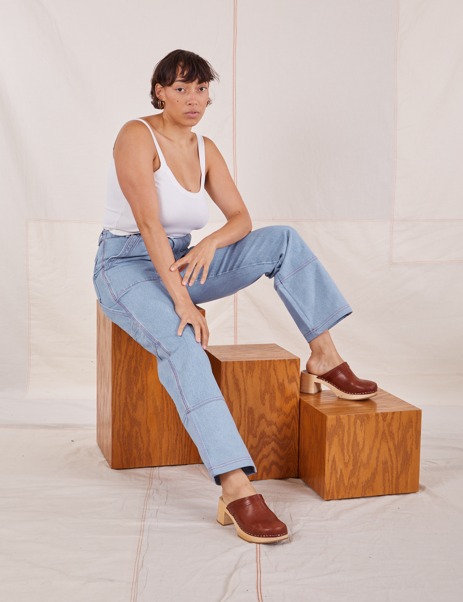 Tiara is wearing Carpenter Jeans in Light Wash and Cropped Cami in vintage tee off-white