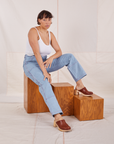 Tiara is wearing Carpenter Jeans in Light Wash and vintage off-white Cami