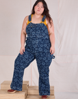 Ashley is 5'7" and wearing 1XL Carpenter Overalls in Lazy Daisy