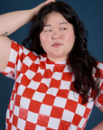 Front close up of Checker Organic Tee in Red on Ashley