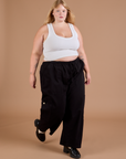 Angled front view of Drop Pocket Cargo Pants in Basic Black and Cropped Tank in vintage tee white worn by Juliet