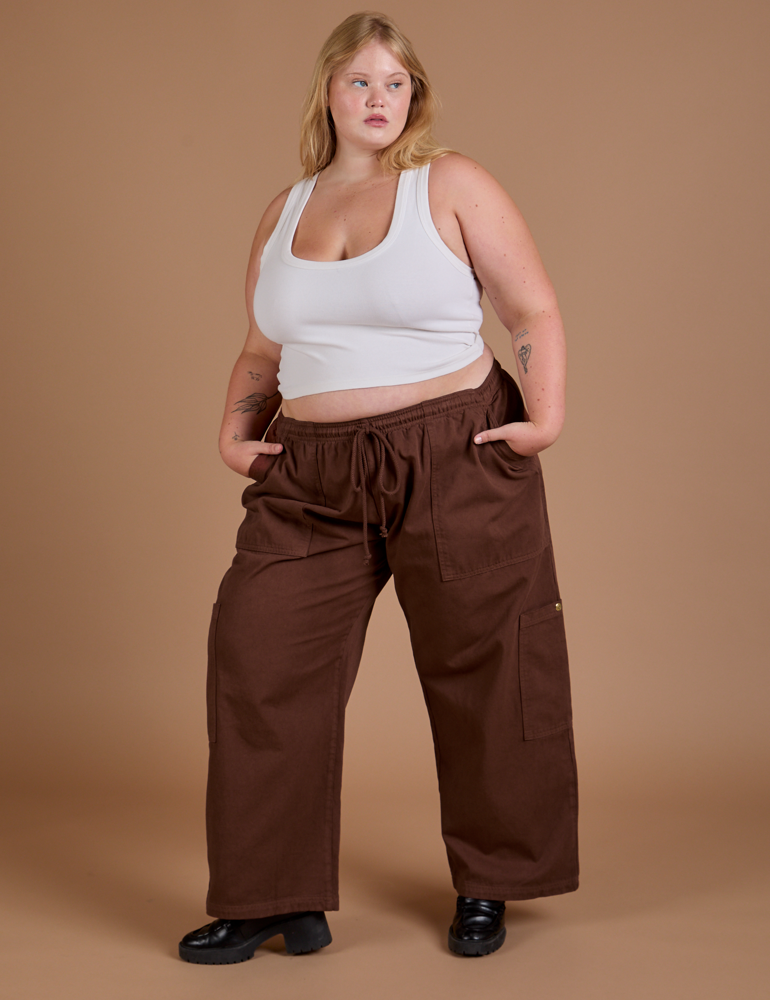 Angled front view of Drop Pocket Cargo Pants in Fudgesicle Brown and Cropped Tank in vintage tee white