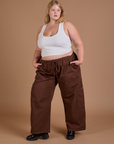 Angled front view of Drop Pocket Cargo Pants in Fudgesicle Brown and Cropped Tank in vintage tee white