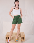 Alex is wearing Easy Shorts in Dark Emerald Green and Cropped Tank in vintage tee off-white
