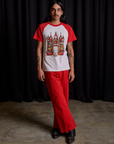 Anthony is wearing Short Sleeve Raglan Tee in Gates of Hell and mustang red Western Pants
