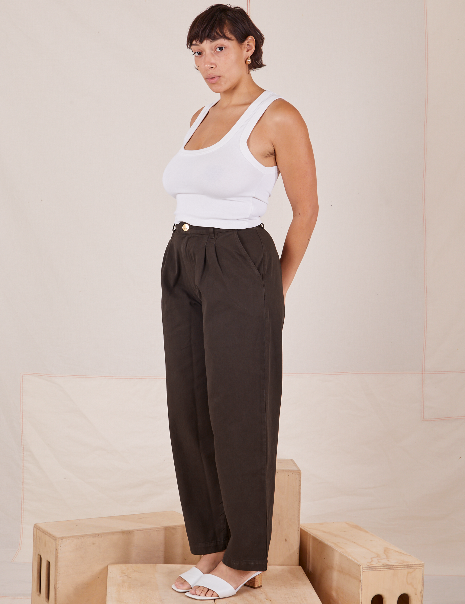 Angled view of Heavyweight Trousers in Espresso Brown and Cropped Tank Top in vintage tee off-white worn by Tiara.