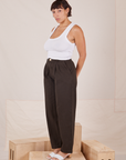 Angled view of Heavyweight Trousers in Espresso Brown and Cropped Tank Top in vintage tee off-white worn by Tiara.