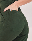 Heritage Short Sleeve Jumpsuit in Swamp Green back pocket close up on Alex