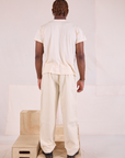 Back view of Heritage Trousers in Natural and Organic Vintage Tee in vintage tee off-white