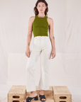 Alex is wearing Racerback Tank in Summer Olive and Western Pants in Vintage Tee Off-White