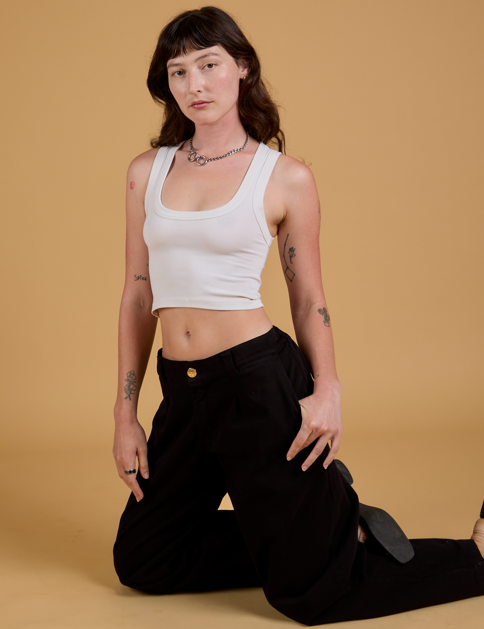 Alex is wearing Baggy Mid-Rise Trousers in Basic Black