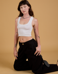 Alex is wearing Baggy Mid-Rise Trousers in Basic Black