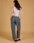 Back view of Baggy Mid-Rise Trousers in Slate Grey and vintage tee white Cropped Tank on Alex