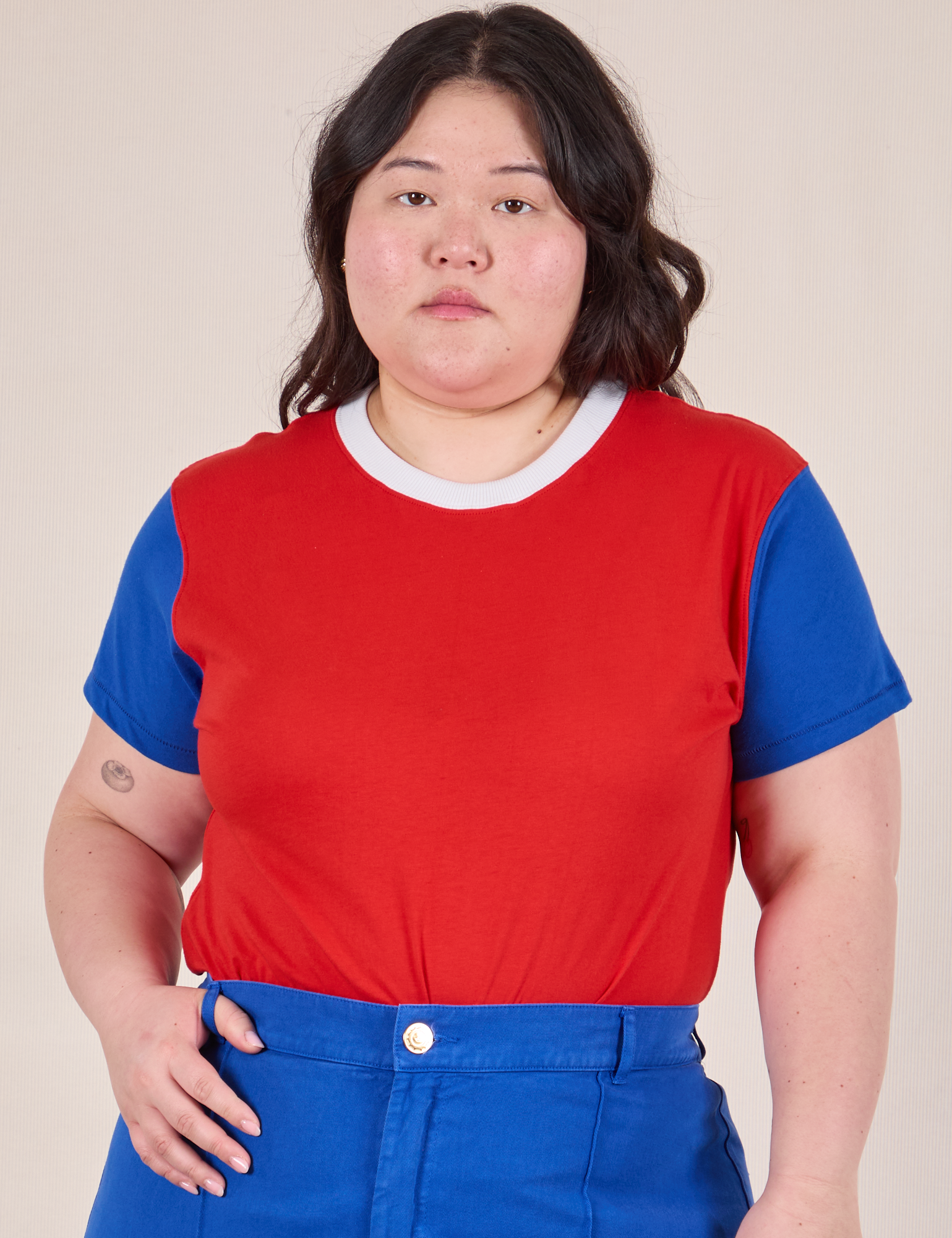 Ashley is 5’7” and wearing L Mismatched Tee in Red & Blue