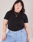 Ashley is 5'7" and wearing L Organic Vintage Tee in Basic Black tucked into light wash Carpenter Jeans
