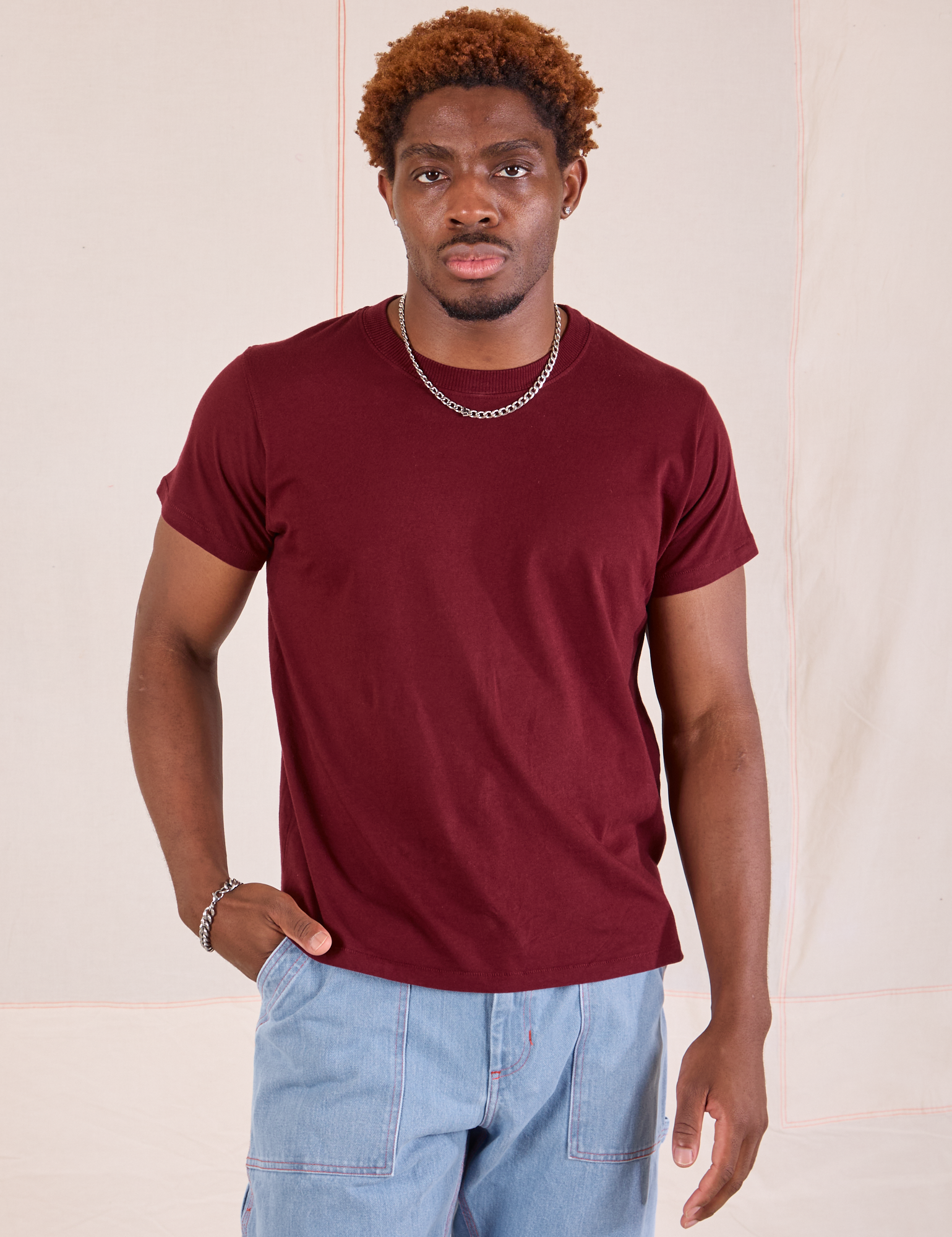 Issac is 5'10" and wearing S Organic Vintage Tee in Red Wine