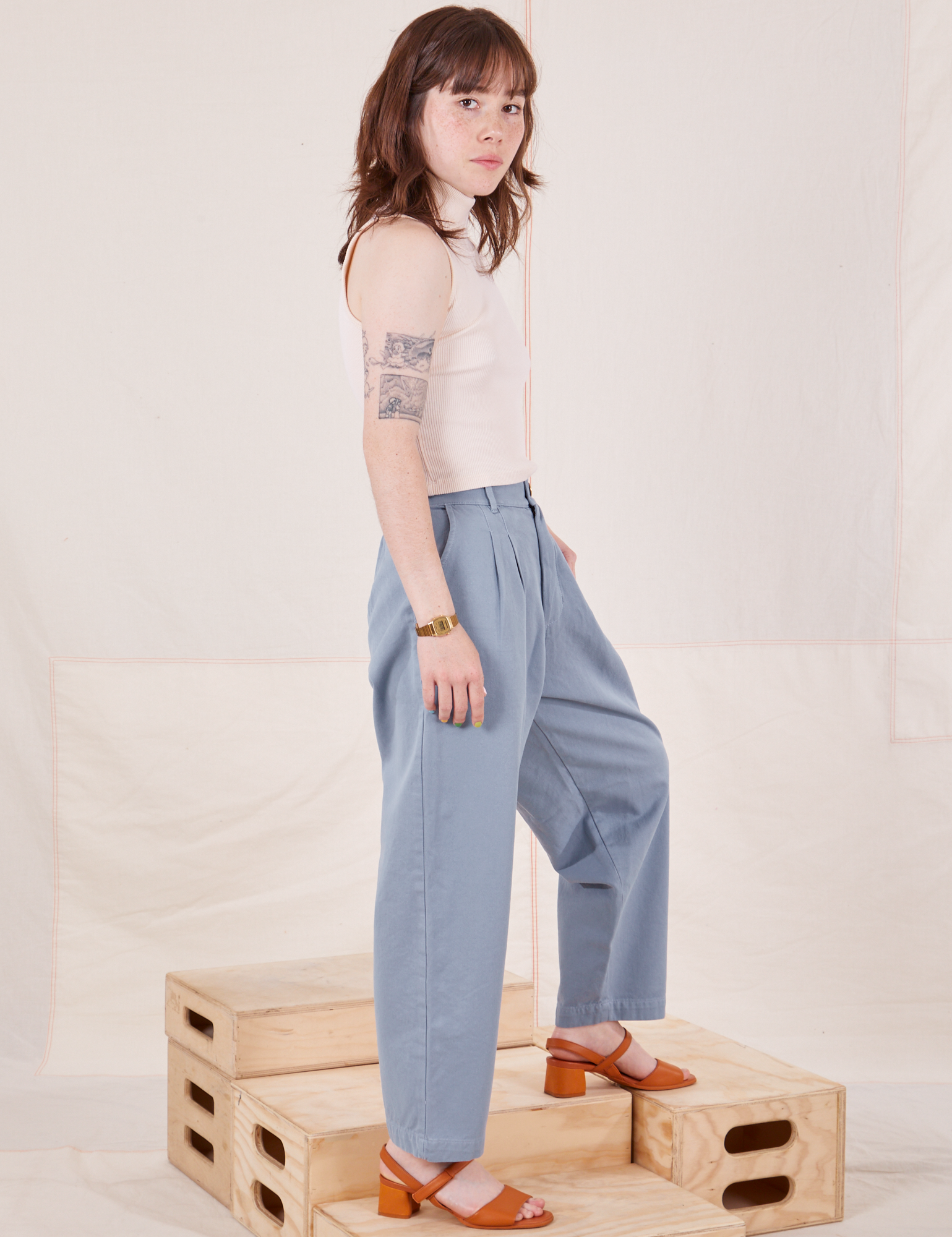 Side view of Organic Trousers in Periwinkle and Sleeveless Turtleneck in vintage tee off-white worn by Hana