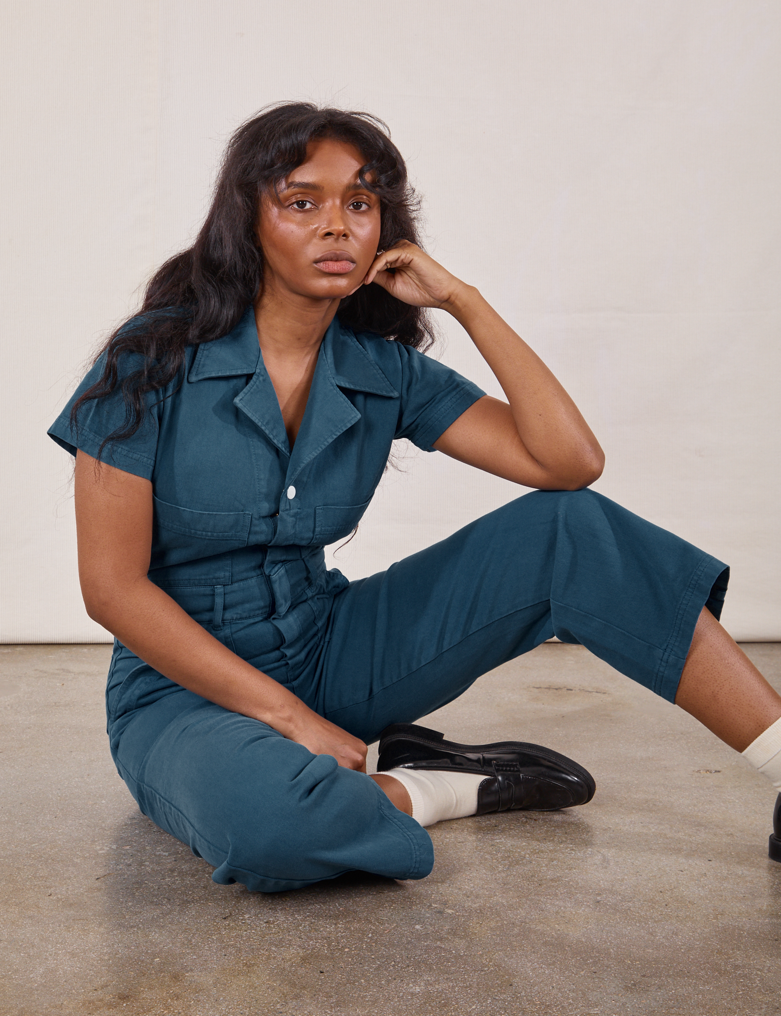 Kandia is wearing Petite Short Sleeve Jumpsuit in Lagoon