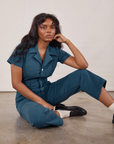 Kandia is wearing Petite Short Sleeve Jumpsuit in Lagoon