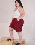 Side view of Railroad Carpenter Shorts in Mustang Red and Cropped Tank in Vintage Tee Off-White on Ashley