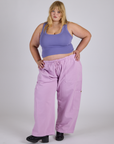 Juliet is 5’7” and wearing 2XL Drop Pocket Cargo Pants in Lilac Purple and faded grape Cropped Tank