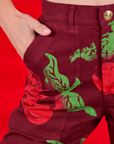 Close up of Madeline's hand in the front pocket of Paintstamped Work Pants in Cherry