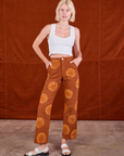 Madeline is 5'9" and wearing XXS Paintstamped Work Pants in Orange paired with a Cropped Tank in vintage tee off-white