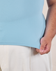 Tank Top in Baby Blue bottom close up with Miguel holding the hem