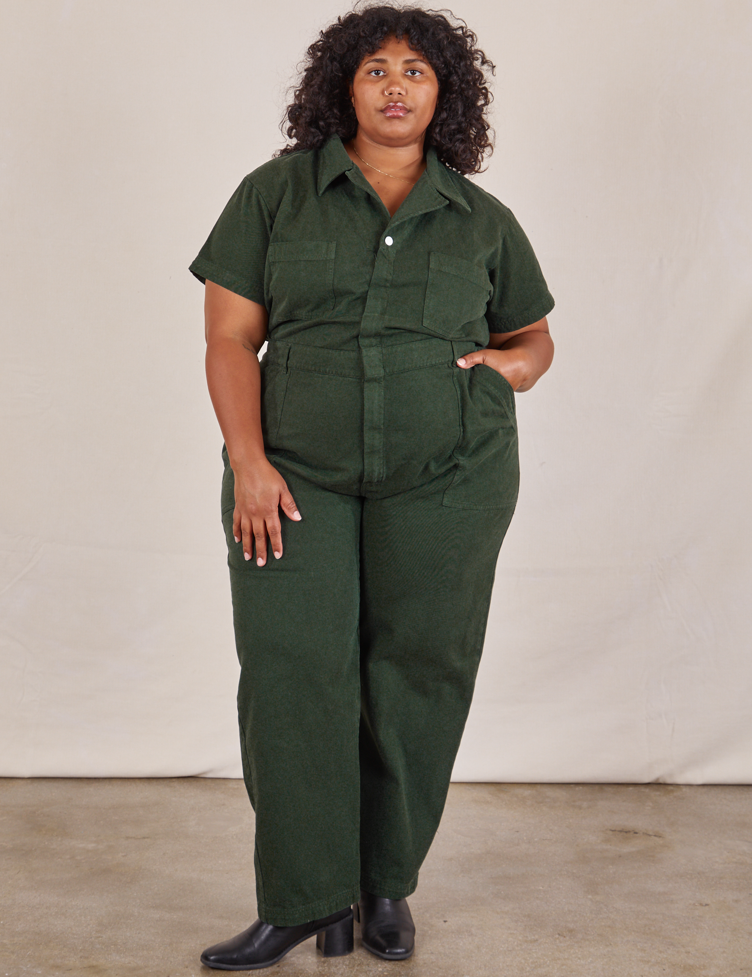 Morgan is 5&#39;5&quot; and wearing 2XL Short Sleeve Jumpsuit in Swamp Green
