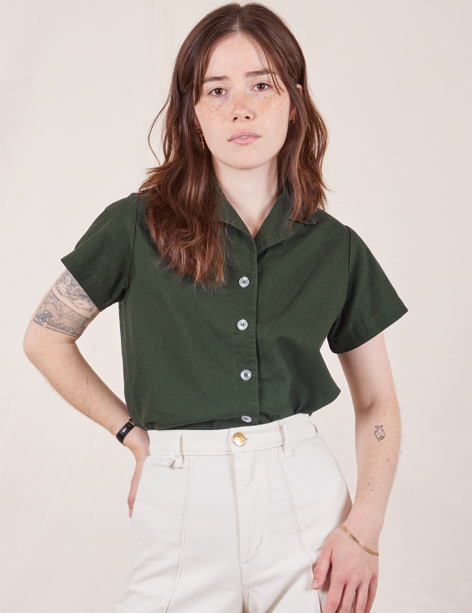 Hana is wearing Pantry Button-Up in Swamp Green tucked into vintage tee off-white Western Pants