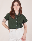 Hana is wearing Pantry Button-Up in Swamp Green tucked into vintage tee off-white Western Pants