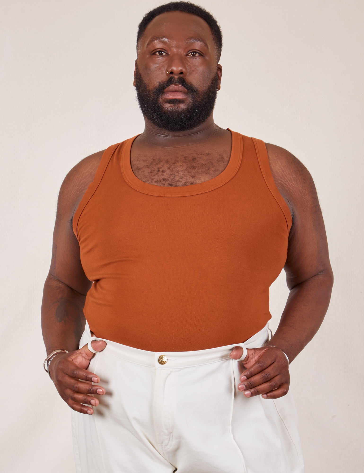 Elijah is wearing Tank Top in Burnt Terracotta