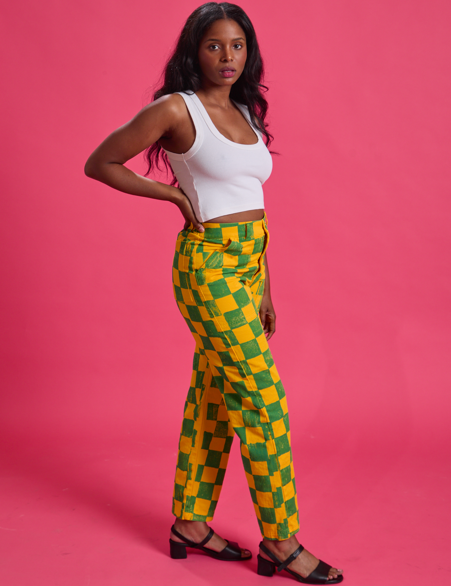 Side view of Checkerboard Work Pants in Green/Yellow and Cropped Tank in Vintage Tee White