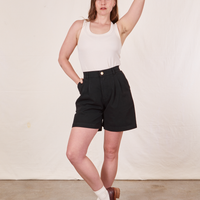Allison is 5'10" and wearing XS Trouser Shorts in Basic Black paired with a vintage off-white Tank Top