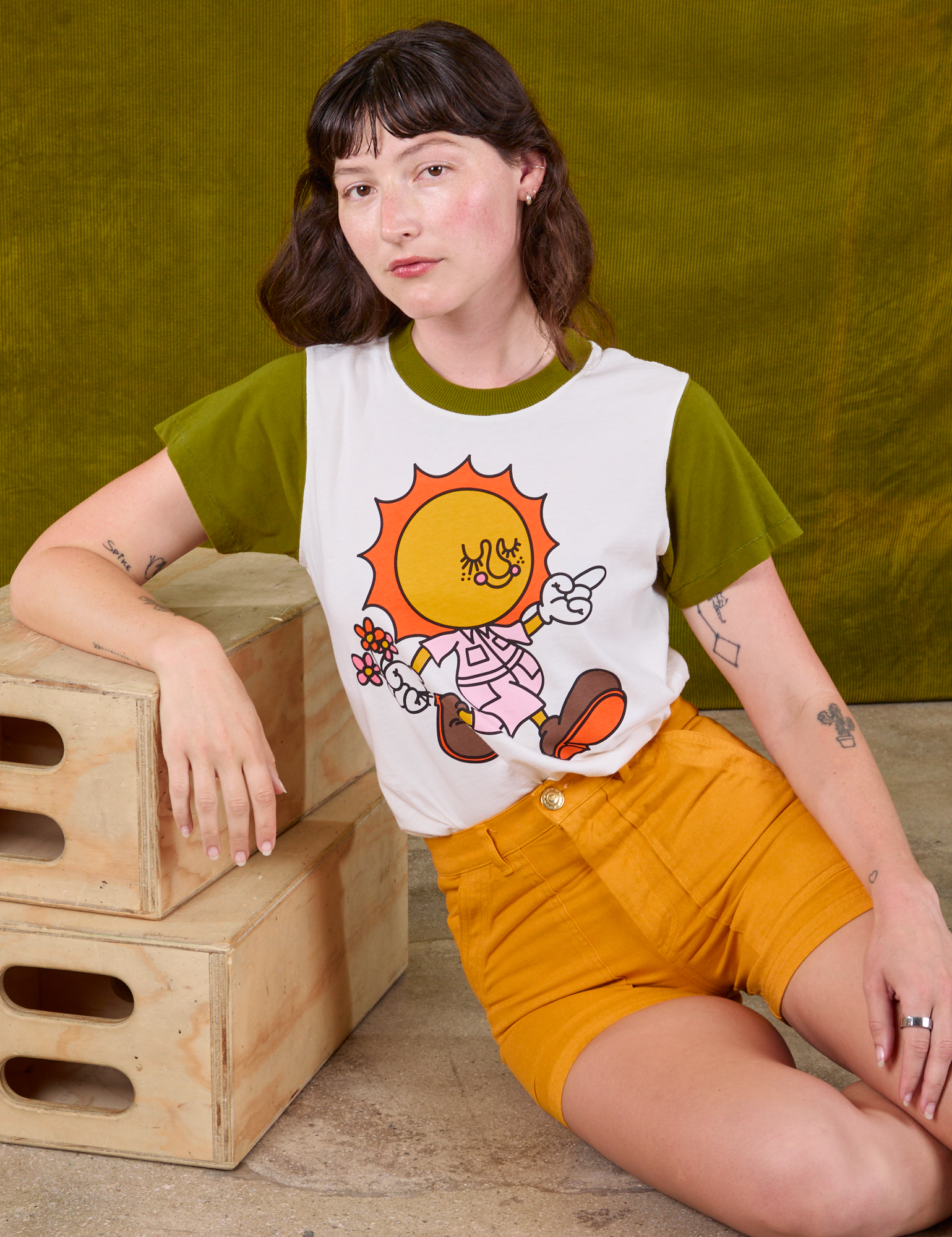 Anniversary Tee in Walkin' On Sun Baby and mustard yellow Work Shorts on Alex